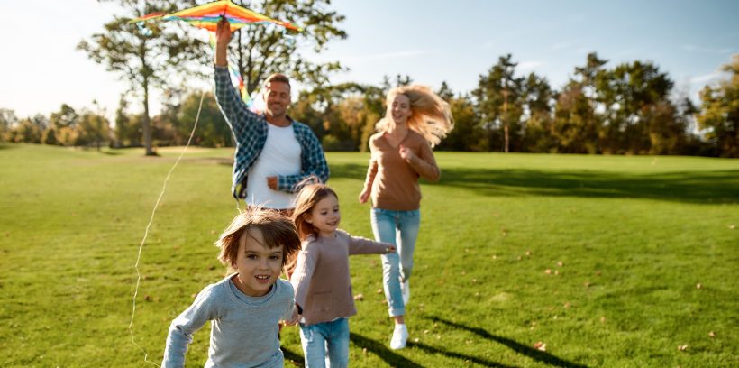Family of four flying a kite