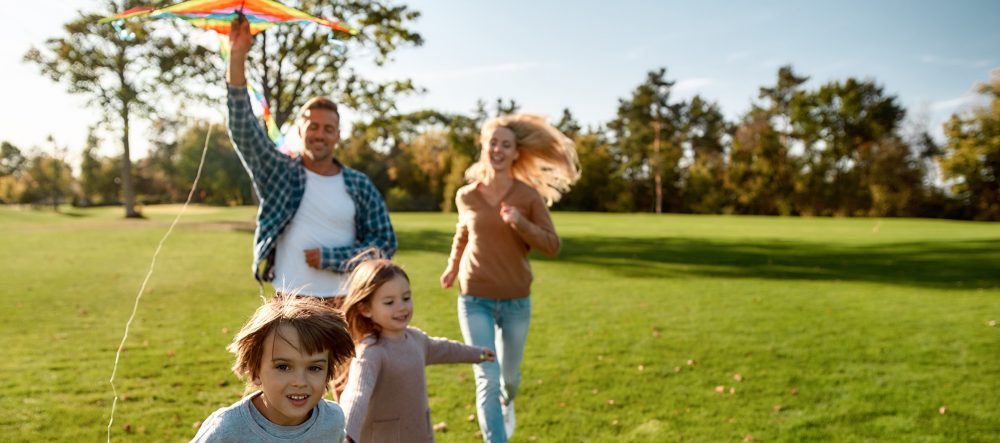 Family of four flying a kite
