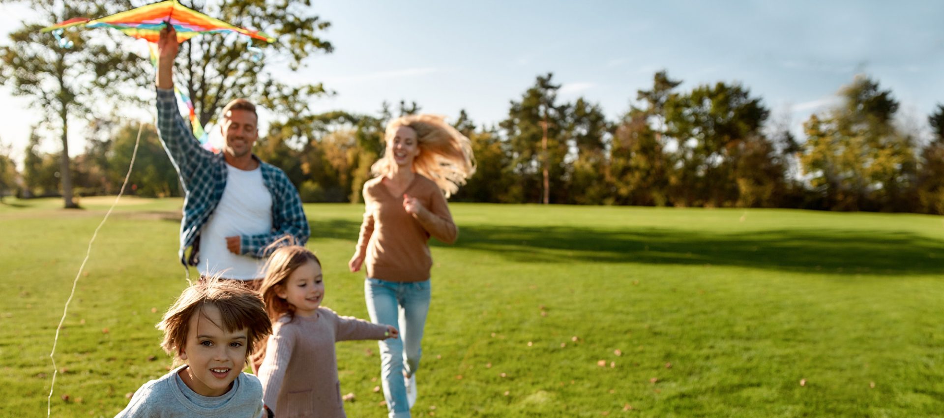 Family of four flying a kite