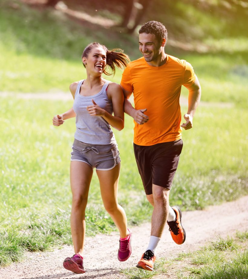 young couple running on trail