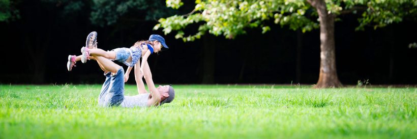 father and daughter playing in the park