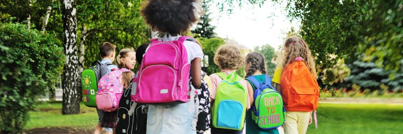 group of school children with bright backpacks